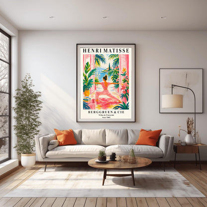 A vertical museum-style exhibition poster with a cream border featuring text for an Henri Matisse exhibition at Berggruen & Cie in Paris,. The colorful central illustration depicts a woman from behind practicing a yoga pose on a pink mat on a terrace. She is framed by open pink shutters and lush green potted plants. Through the open doors is a scenic view of a bright blue sea with sailboats, a coastal hill town, and green palm trees under a sunny sky.