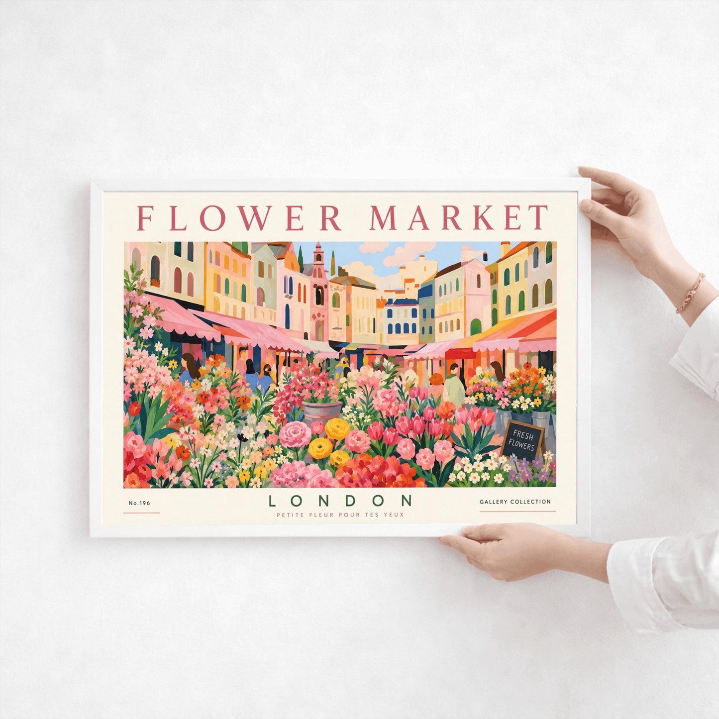 A vintage-style exhibition poster titled "FLOWER MARKET" at the top and "LONDON" at the bottom. The illustration depicts a vibrant open-air market scene packed with dense stalls of pink tulips, yellow ranunculus, and assorted green foliage. In the background, a row of colorful, multi-story pastel buildings stands under a light blue sky with soft white clouds, with shoppers walking between the stalls.