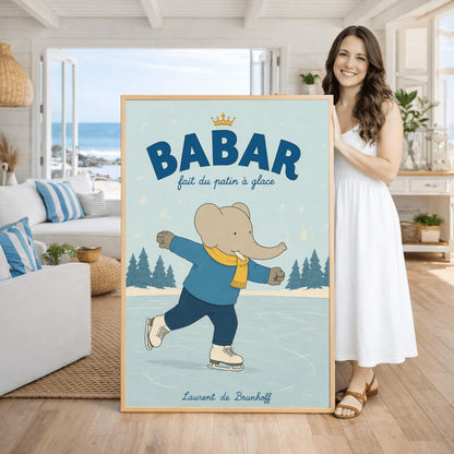 A vertical storybook-style art print featuring Babar the Elephant ice skating on a frozen pond. Babar is wearing a blue sweater, dark pants, a yellow scarf, and white ice skates. He is shown mid-stride with one leg lifted. The background consists of snowy pine trees under a light blue sky with falling snowflakes. The top of the print reads "BABAR fait du patin à glace" with a small gold crown.