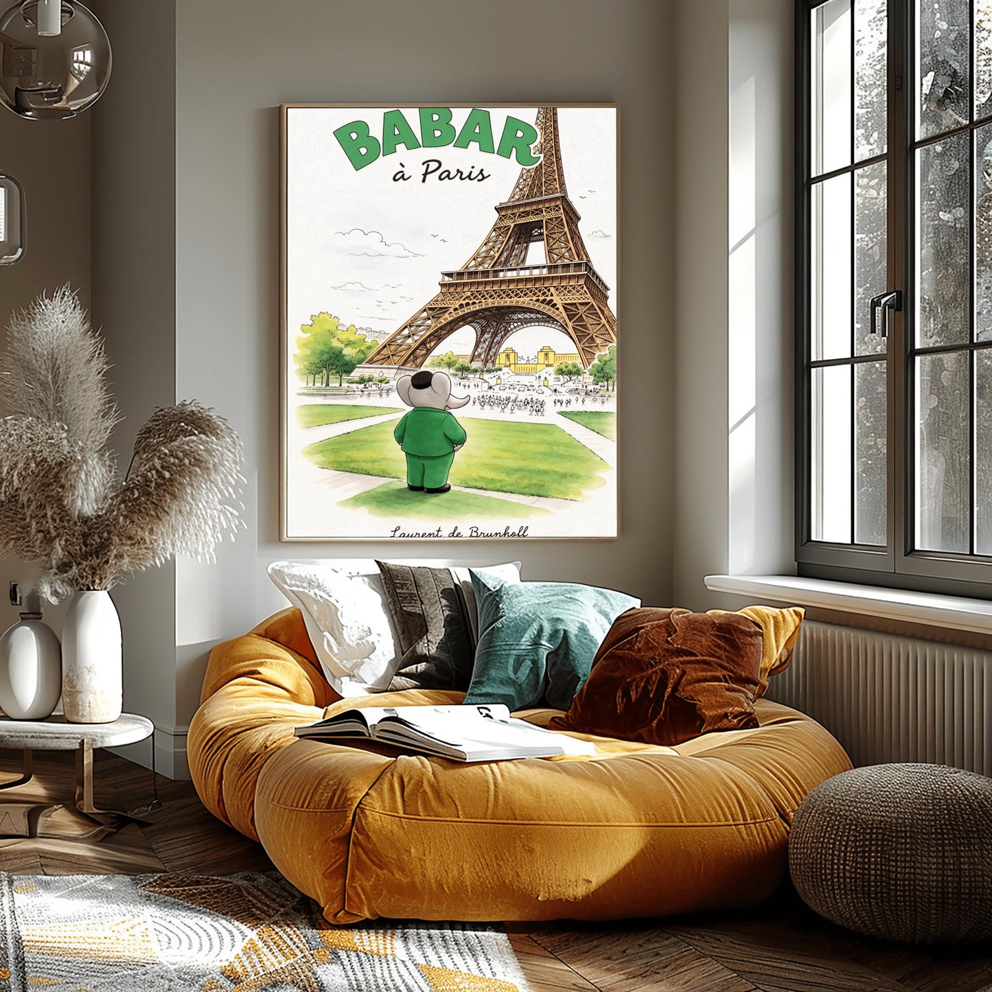 A vertical art print titled "BABAR à Paris" in large green letters. A grey elephant, Babar, seen from behind wearing a green suit and black cap, stands on a green lawn looking toward the massive Eiffel Tower. The scene includes green trees, a distant cityscape with crowds of people, and a soft blue sky. The artist's name, "Laurent de Brunhoff," is printed in script at the bottom.