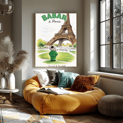 A vertical art print titled "BABAR à Paris" in large green letters. A grey elephant, Babar, seen from behind wearing a green suit and black cap, stands on a green lawn looking toward the massive Eiffel Tower. The scene includes green trees, a distant cityscape with crowds of people, and a soft blue sky. The artist's name, "Laurent de Brunhoff," is printed in script at the bottom.