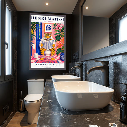 A vertical art print styled as a Henri Matisse exhibition poster. In the center, a tiger sits on a toilet in a pink bathroom, reading a newspaper with pink floral pants at its ankles. The room is decorated with lush tropical plants, a blue door, and a small Matisse-style blue cutout art piece on the wall. The text "HENRI MATISSE" is at the top, and "BERGGRUEN & CIE" is at the bottom.