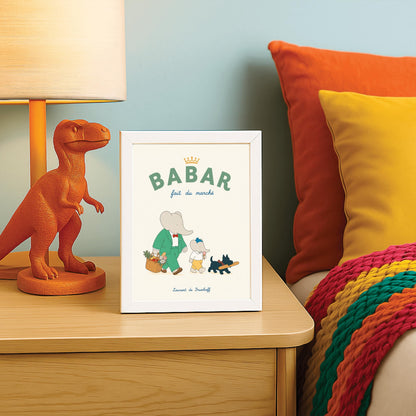 A vertical storybook-style art print of Babar the Elephant walking home from a market against a cream background. Babar is in a green suit and red bow tie, carrying a basket of fruit and flowers. Beside him is a smaller elephant eating an ice cream cone and a small black dog in a plaid collar carrying a baguette. The top text reads "BABAR fait du marché" with a gold crown.