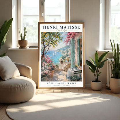 A vertical retro French exhibition poster for Henri Matisse Côte d'Azur on a wide ivory border, as seen in Screenshot 2026-06-06 at 23.18.59.png. The main image shows a beautiful summer illustration of a stone terrace overlooking the blue Mediterranean Sea where two white sailboats float. On the terrace, two women wearing white dresses and straw hats sit facing the water. To the left stands a green lemon tree with yellow fruit and large pots of pink and white flowers.
