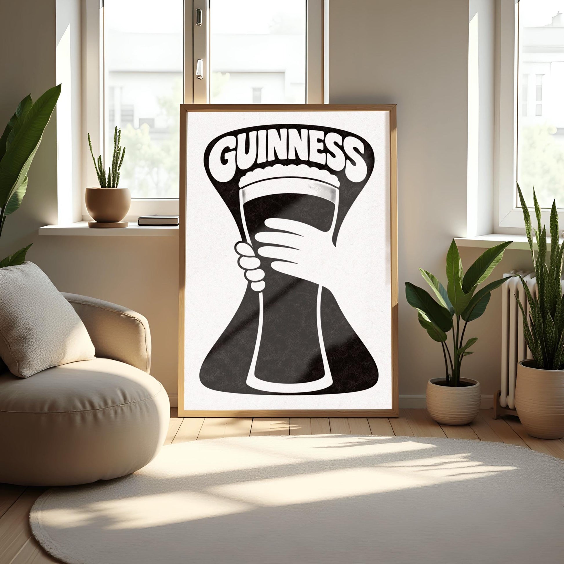 A vertical minimalist graphic in black and white. A large, black hourglass-shaped background features a white hand silhouette holding a pint glass made of negative space. The word "GUINNESS" is arched in bold white text at the top.