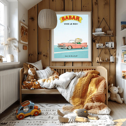 A vertical children's illustration poster. At the top, a yellow banner reads "BABAR" in red letters, with "VIVE LE ROI!" written in black below it. At the bottom, King Babar in a green suit and crown is driving a large, salmon-pink vintage convertible car with white tires. The car is on a simple blue road with white lines, and the background is a solid light blue sky. The name "Jean de Brunhoff" is at the bottom.
