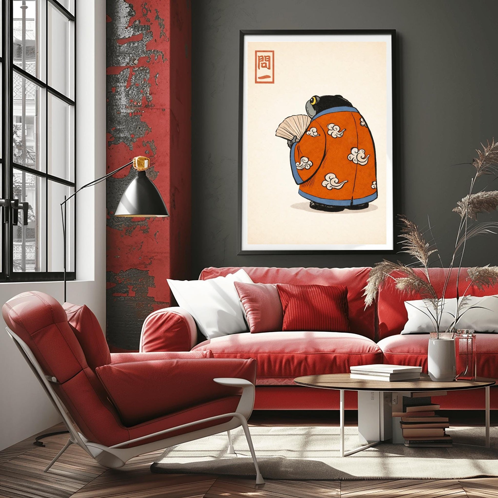 A vertical Japanese woodblock-style art print of a large, dark grey-black frog seen from behind. The frog is wearing an ornate burnt orange kimono decorated with white cloud motifs and blue piping. It holds a beige folding fan in its small hand. In the top left corner is a red rectangular stamp containing Japanese calligraphy. The entire image is set against a textured, pale cream background in a minimalist aesthetic.