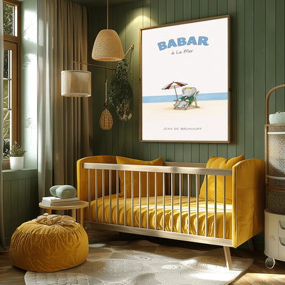 A vertical children's illustration poster titled "BABAR à La Mer" in light blue. In the center, an elephant (Babar) in a green suit and crown is sitting in a wooden lounge chair on a sandy beach. A red and white striped umbrella is behind him. In the background, a thin blue line represents the sea under a white sky. The name "JEAN DE BRUNHOFF" is at the bottom.