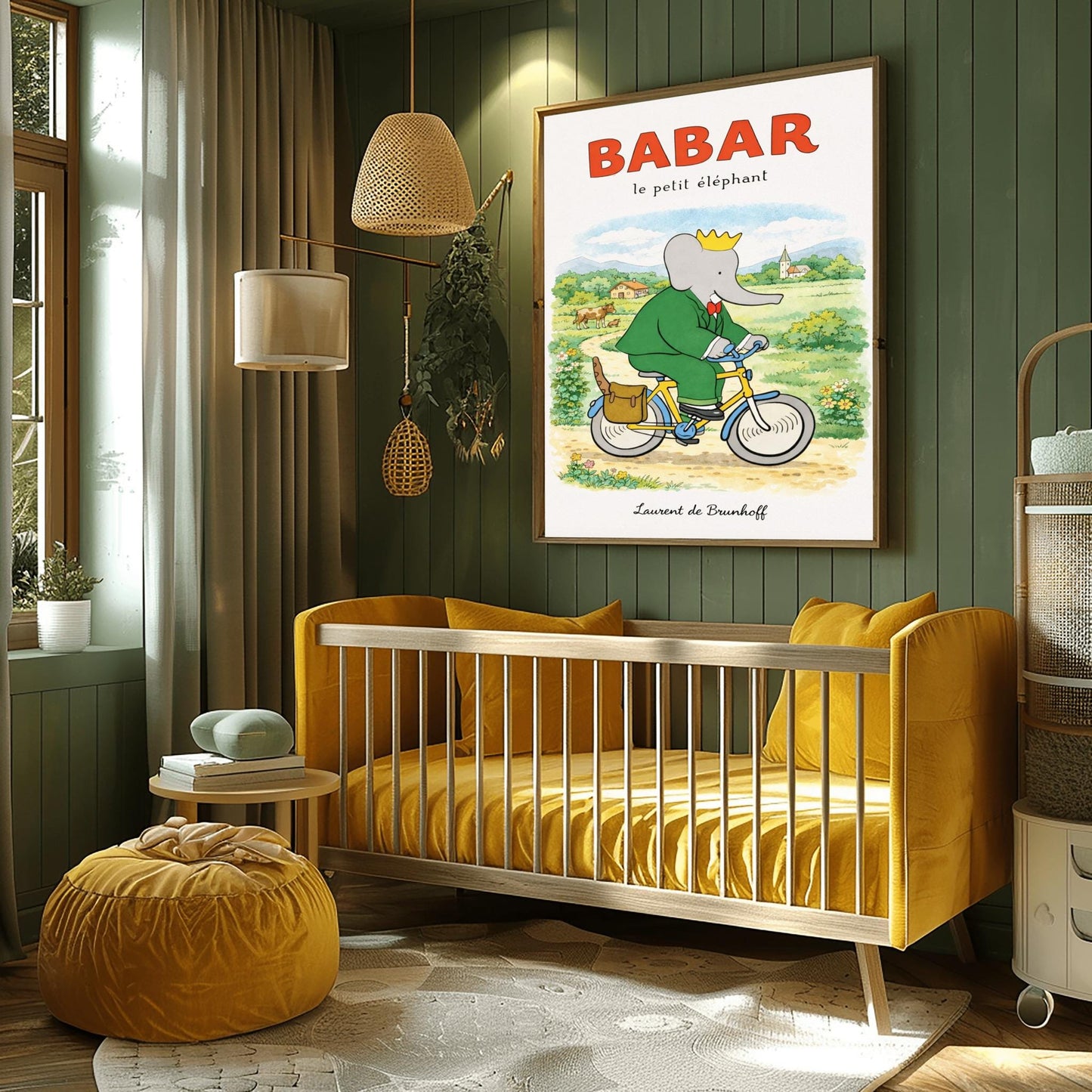 A vertical children's illustration poster titled "BABAR le petit éléphant" at the top in red. King Babar, in a green suit and crown, is riding a yellow bicycle along a dirt path. A brown leather bag on the back of the bike holds a baguette. The background shows a green meadow with a cow and calf, small bushes with flowers, and a distant house and church under a soft sky. The name "Laurent de Brunhoff" is at the bottom.