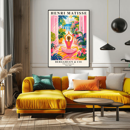 A vertical maximalist art print styled as a Henri Matisse exhibition poster. A woman with blonde hair tied back is seen from behind, sitting on a yellow-and-orange striped yoga mat in a yoga pose with her hands joined above her head. She faces open pink French doors that lead to a balcony with a view of a blue sea and a distant city. The terrace is filled with vibrant pink flowers, large green tropical plants in yellow pots, and a small wooden stool.