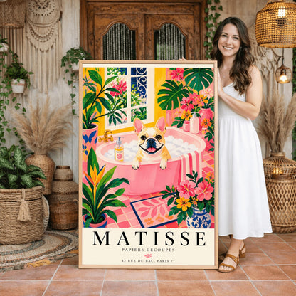 A vertical maximalist art print styled as a Henri Matisse exhibition poster. A tan and white French Bulldog with a wide, happy smile sits in a pink bathtub filled with white bubbles. The bathroom is vibrant with pink tiled floors, yellow walls, and a large window looking out onto a garden. The scene is filled with tropical plants like Monstera and Birds of Paradise. Bold black text at the bottom reads "MATISSE PAPIERS DÉCOUPÉS" with a Paris gallery address.