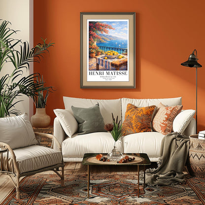 A vertical painterly illustration of a stone terrace with a black iron railing. A pink bougainvillea tree hangs from the top left over a wooden table with a bowl of oranges and lemons. Beyond the railing is a blue sea with white sailboats and a distant mountainous coastline.