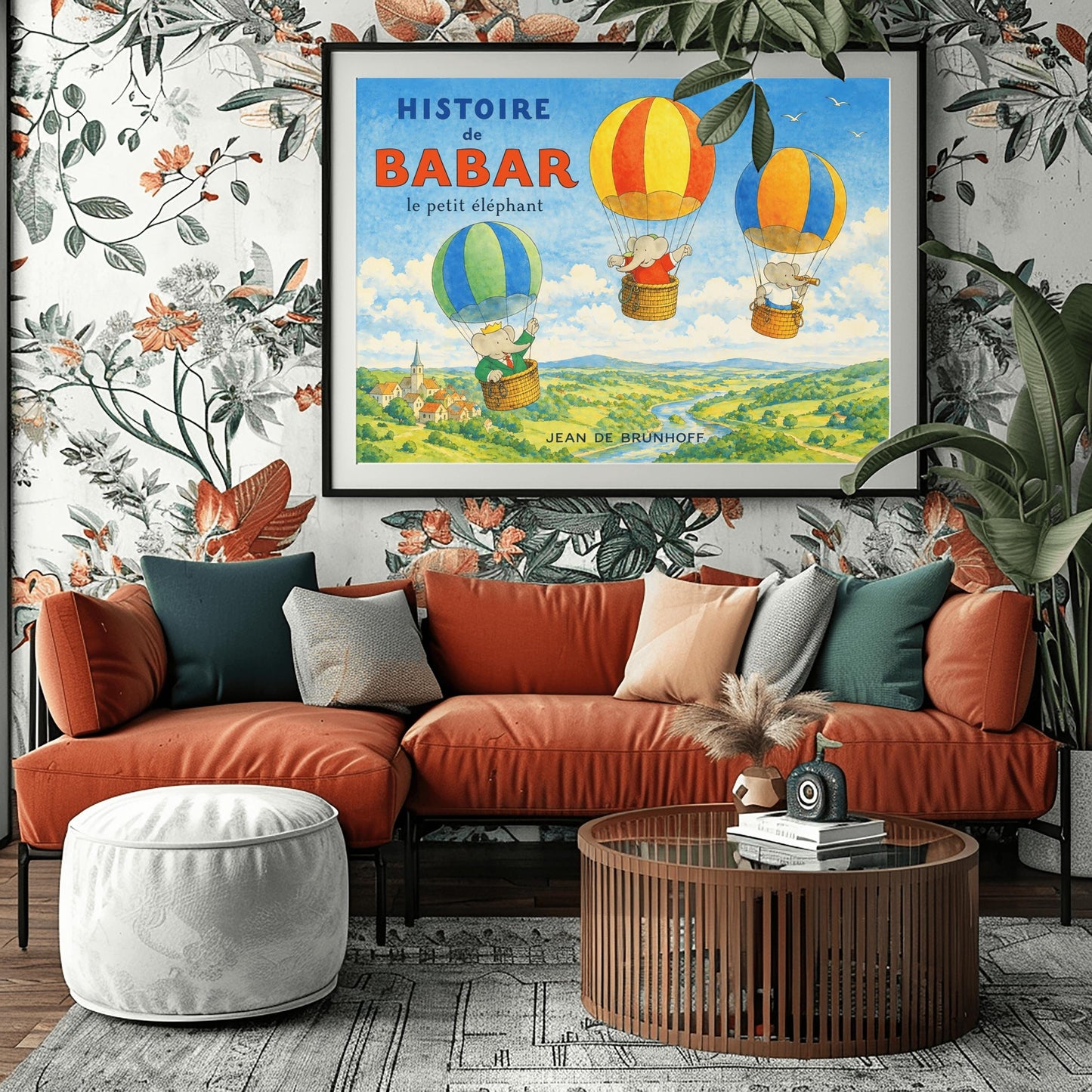 A horizontal watercolor illustration for "Histoire de Babar" showing three elephants in hot air balloons floating over a lush green valley with a river and a small village. On the left, Babar wears a crown and green suit in a blue and green balloon. Two other elephants are in red/orange and blue/yellow balloons. The sky is blue with a few white birds. The title is in large blue and red letters at the top left.