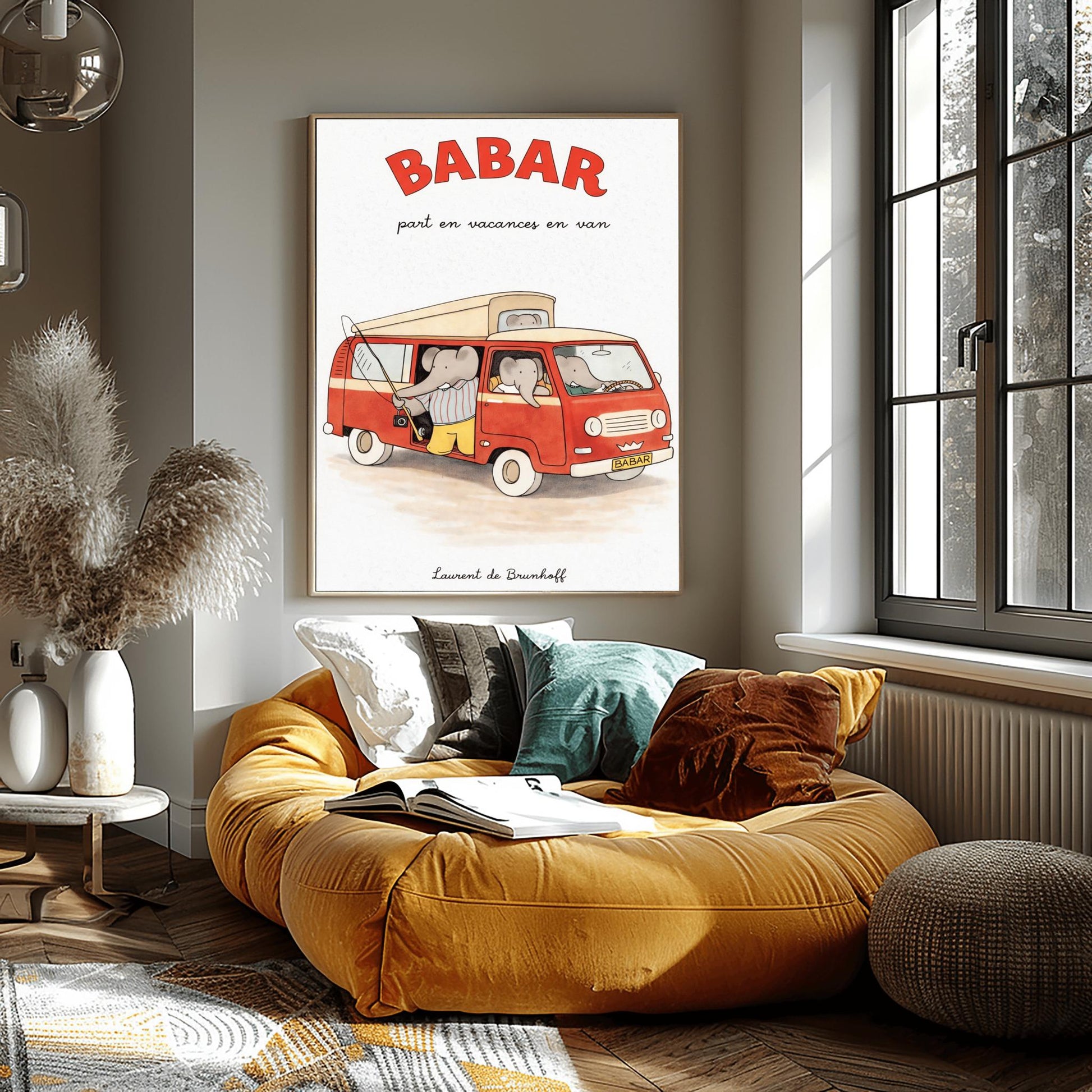 A vertical art print titled "BABAR part en vacances en van" in large red letters. A retro red and cream camper van is filled with grey elephants. One elephant in a striped shirt holds a fishing rod out the side door, and another sits in the driver's seat. The van has a "BABAR" license plate and a gold crown symbol on the grill. The artist's name, "Laurent de Brunhoff," is at the bottom of the cream-colored, textured background.
