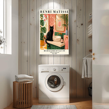 A vertical art print styled as a Henri Matisse exhibition poster. A sleek black cat with bright green eyes sits on a cream-colored bathroom vanity next to a white vessel sink. The bathroom features blush pink walls and emerald green tiles. A gold-framed mirror reflects a Matisse leaf print. Lush green plants and pink flowers frame the scene, and dappled sunlight creates shadows on the wall. The poster has bold black text at the top and bottom with the gallery name Berggruen & Cie.