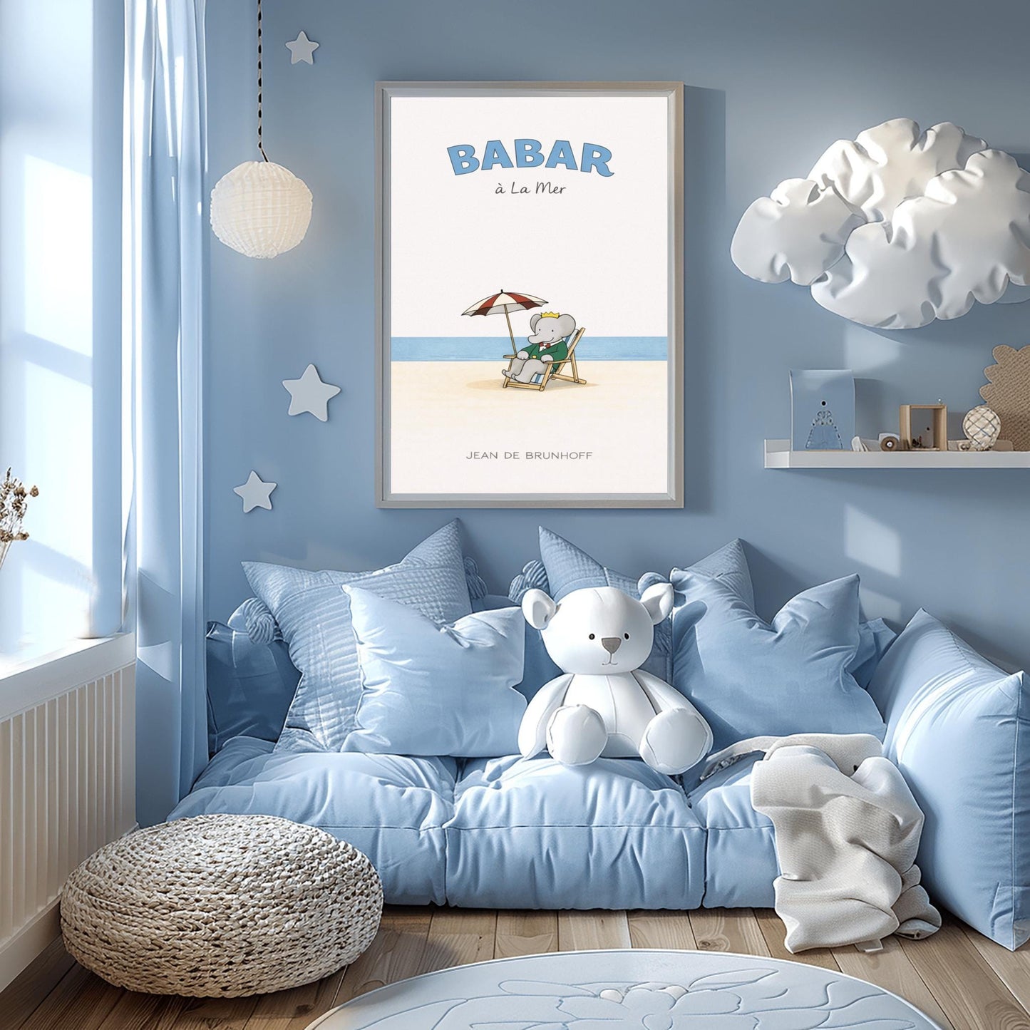 A vertical children's illustration poster titled "BABAR à La Mer" in light blue. In the center, an elephant (Babar) in a green suit and crown is sitting in a wooden lounge chair on a sandy beach. A red and white striped umbrella is behind him. In the background, a thin blue line represents the sea under a white sky. The name "JEAN DE BRUNHOFF" is at the bottom.
