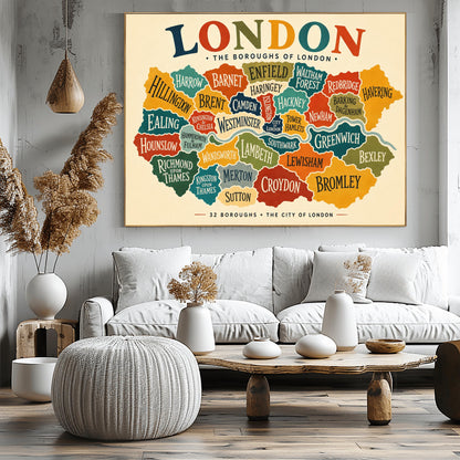A horizontal vintage-style fine art exhibition poster mapping the boroughs of London. Set on a warm cream background with a wide border, the poster features a colorful, interlocking map of London's districts in shades of teal, orange, green, and yellow, with the River Thames running through the middle. A large, multicolored heading at the top reads "LONDON" and text at the bottom reads "32 BOROUGHS + THE CITY OF LONDON".