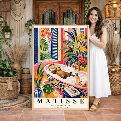 A vertical maximalist art print designed as a Henri Matisse exhibition poster. A brown otter floats on its back in a pink bubble bath, holding a small yellow rubber ducky. The bathtub has a blue and yellow floral pattern. The room is filled with vibrant tropical plants, pink walls, and yellow checkered tiles. A blue-shuttered window looks out onto a sunny garden. In the foreground, an art book and a striped vase are visible. Bold black text at the bottom reads "MATISSE PAPIERS DÉCOUPÉS"