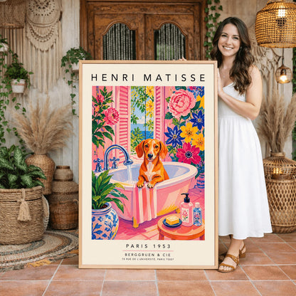 A vertical maximalist art print styled as a Henri Matisse exhibition poster. A brown Dachshund dog sits in a pink bathtub while water pours from a silver faucet. The room features vibrant pink walls and floors, decorated with very large pink, blue, and yellow flowers. A blue and white floral pot sits in the foreground along with a small stool holding soap and bottles. An open window in the background shows a blue sea and green leaves.