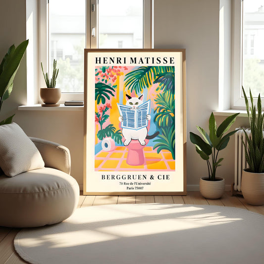 A whimsical, colorful poster in the style of Henri Matisse features an orange and black striped cat with green eyes sitting on a toilet, intently reading a blue-and-white striped newspaper. The bathroom setting is rendered in bold, flat blocks of color, dominated by pink, yellow, and green, with large leafy plants surrounding the cat. A roll of toilet paper is visible to the left. At the top, "HENRI MATISSE" is written in black capital letters.