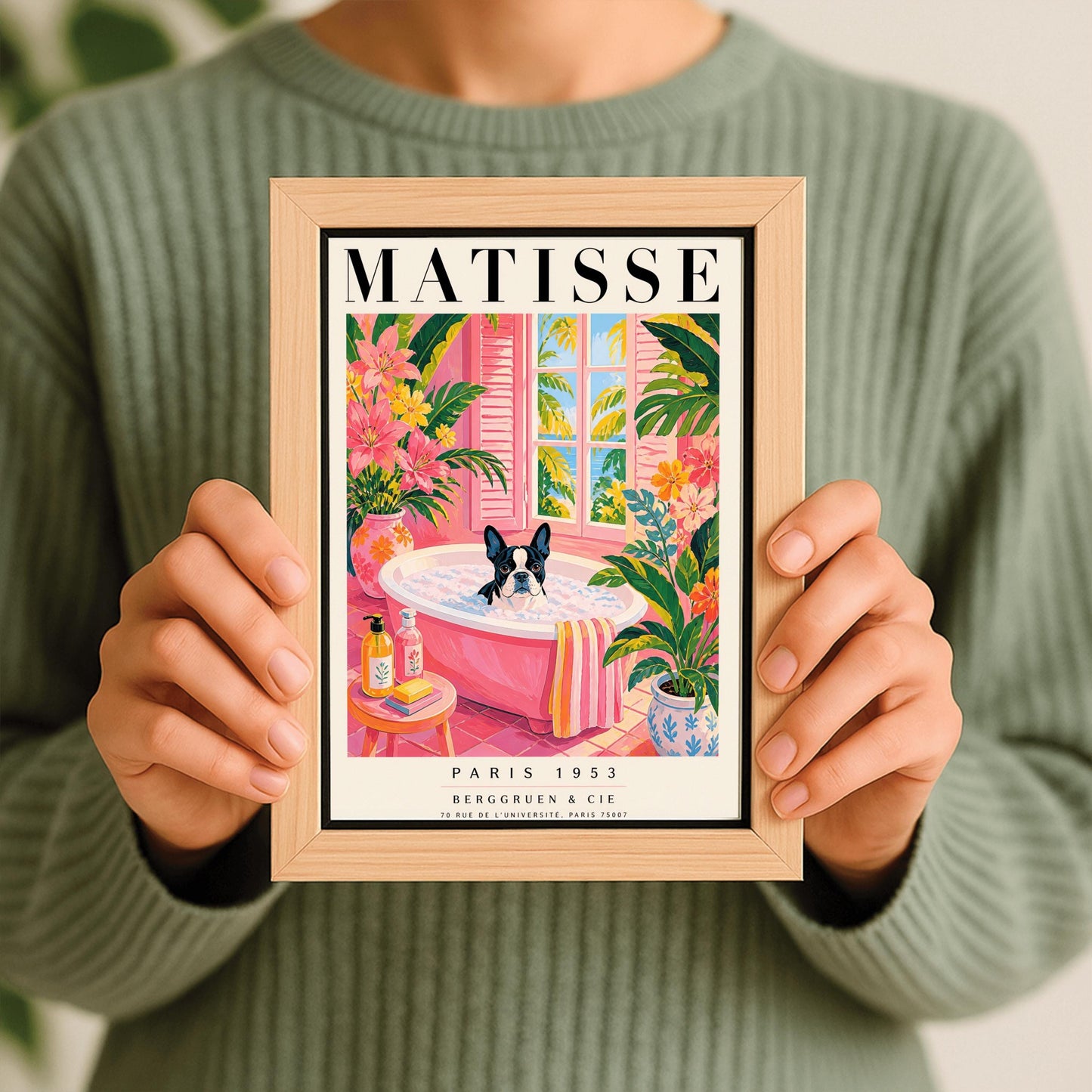 A vertical maximalist art print styled as a Henri Matisse exhibition poster. A black and white Boston Terrier dog sits in a pink bathtub filled with white bubbles. The bathroom features pink tiled floors and walls, decorated with lush green tropical plants and vibrant pink flowers in floral vases. A window with pink shutters in the background looks out onto palm trees and a blue ocean. In the foreground, soap bottles and a yellow bar of soap sit on a small pink stool.