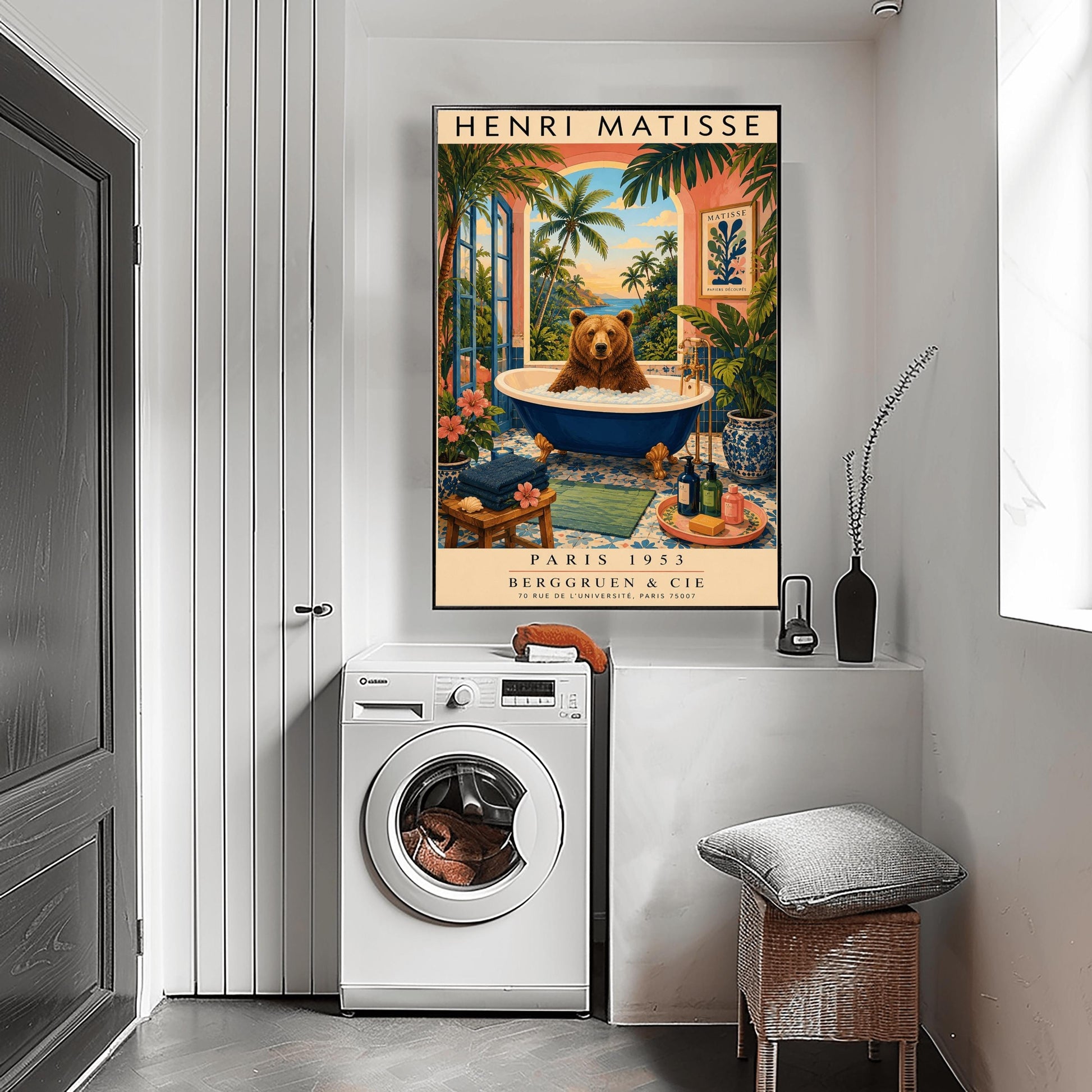 A vertical retro Henri Matisse exhibition poster on a wide cream border. The main image shows a surreal illustration of a large brown bear taking a bubble bath in a navy blue clawfoot tub with gold feet. The bathroom features blue patterned floor tiles, a pink wall with a framed Matisse cut-out poster, and a massive open arch window overlooking a tropical beach with palm trees and a blue ocean at sunset