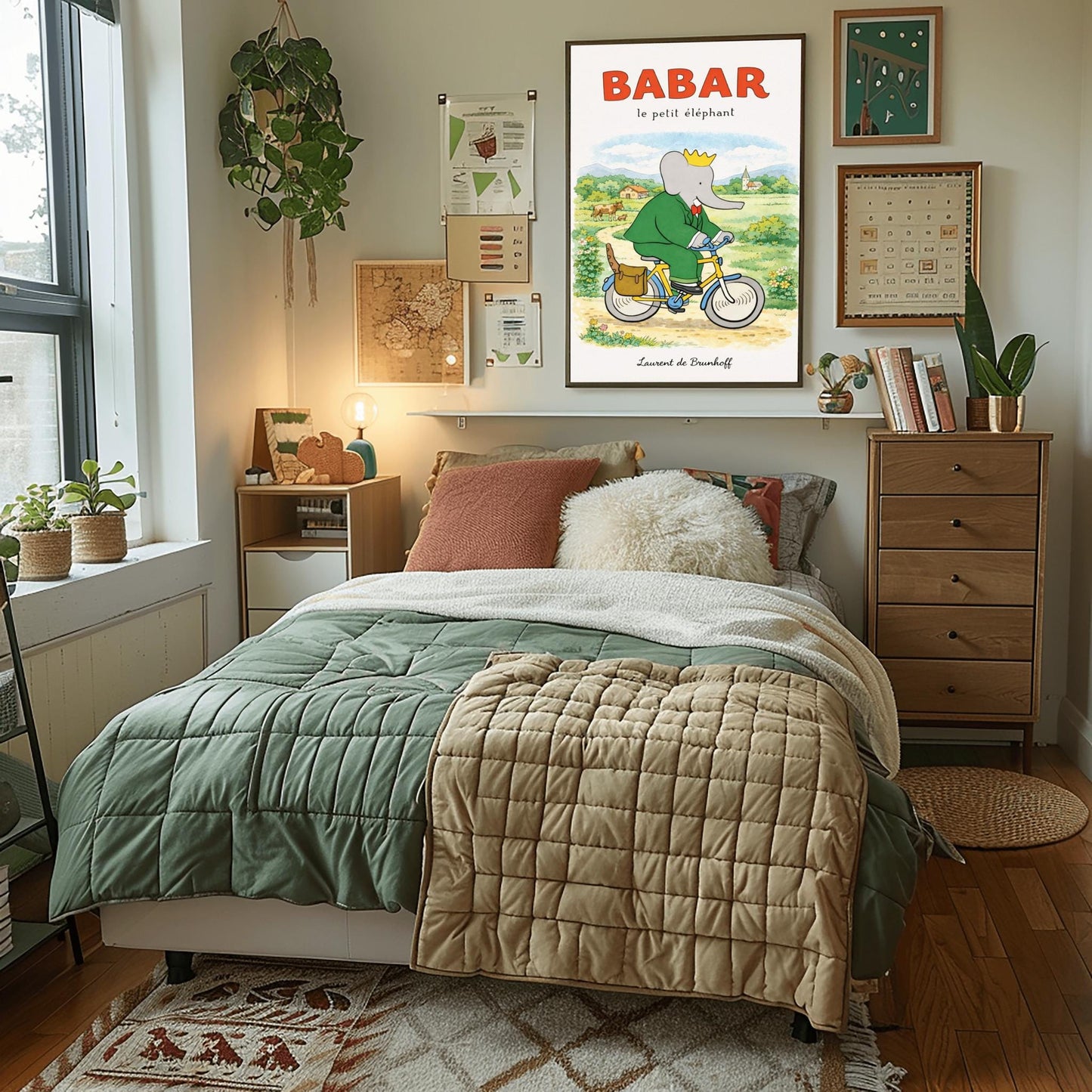 A vertical children's illustration poster titled "BABAR le petit éléphant" at the top in red. King Babar, in a green suit and crown, is riding a yellow bicycle along a dirt path. A brown leather bag on the back of the bike holds a baguette. The background shows a green meadow with a cow and calf, small bushes with flowers, and a distant house and church under a soft sky. The name "Laurent de Brunhoff" is at the bottom.