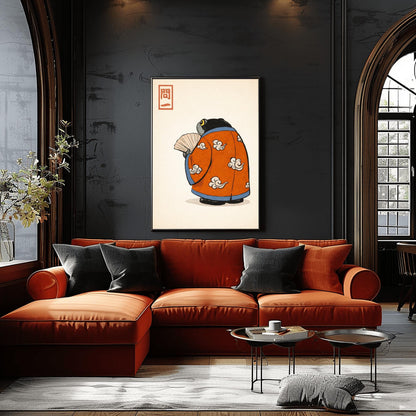 A vertical Japanese woodblock-style art print of a large, dark grey-black frog seen from behind. The frog is wearing an ornate burnt orange kimono decorated with white cloud motifs and blue piping. It holds a beige folding fan in its small hand. In the top left corner is a red rectangular stamp containing Japanese calligraphy. The entire image is set against a textured, pale cream background in a minimalist aesthetic.