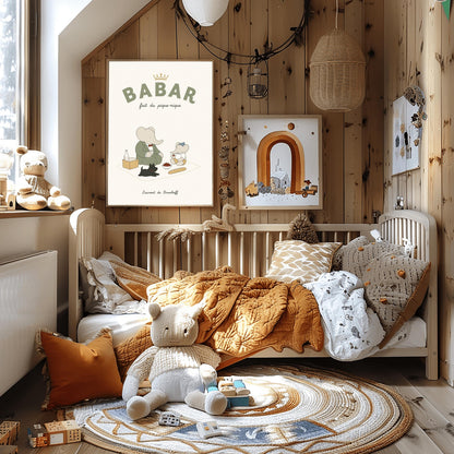 A vertical storybook-style art print of Babar the Elephant having a picnic against a cream background. Babar, in a green suit, sits on a white blanket with a smaller elephant in a blue hat and yellow shorts. A small black dog lies in the foreground. The spread includes a baguette, a bowl of cherries, and a bottle. The top reads "BABAR fait du pique-nique" with a gold crown, and the bottom says "Laurent de Brunhoff."