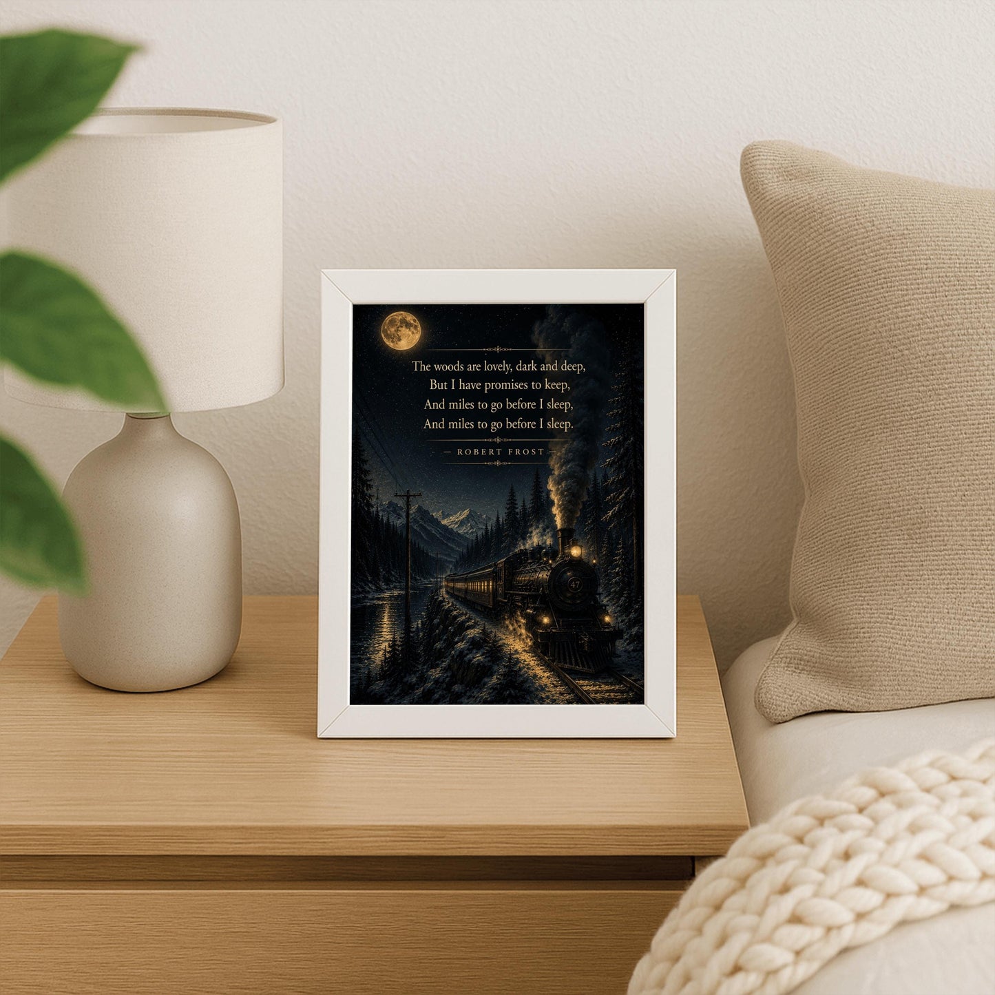 A vertical art print showing a vintage steam locomotive traveling on a snowy track at night. The train, with glowing windows and smoke billowing from its stack, moves along a lakeside beneath high mountains. A large full moon and stars light the sky, creating a reflection on the water. The final lines of Robert Frost’s "Stopping by Woods on a Snowy Evening" are printed in gold in the upper portion of the image.