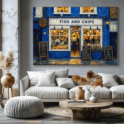 A horizontal impressionist painting of a "Fish and Chips" shop at night. The building is a vibrant cobalt blue with thick, textured brushstrokes. Large, bright windows reveal a warm yellow interior where chefs are working. Outside, three wooden chalkboard signs list the menu and "The Nation's Favourite." The wet pavement reflects the golden light from the shop's interior and blue exterior lamps. A sign on the right reads "10 The Strand."