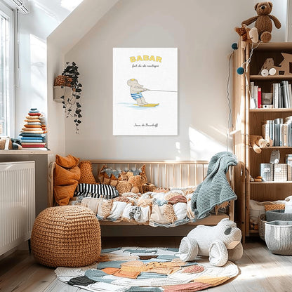 A vertical art print titled "BABAR fait du ski nautique" in yellow letters. A grey elephant, Babar, is wearing blue and white striped swim trunks and a gold crown while water skiing. He is holding onto a tow rope and gliding on two yellow skis over a light blue splash of water. The background is a minimalist cream texture with the name "Jean de Brunhoff" at the bottom.