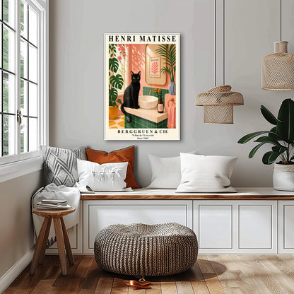 A vertical art print styled as a Henri Matisse exhibition poster. A sleek black cat with bright green eyes sits on a cream-colored bathroom vanity next to a white vessel sink. The bathroom features blush pink walls and emerald green tiles. A gold-framed mirror reflects a Matisse leaf print. Lush green plants and pink flowers frame the scene, and dappled sunlight creates shadows on the wall. The poster has bold black text at the top and bottom with the gallery name Berggruen & Cie.