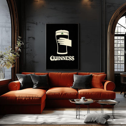 A vertical minimalist graphic design on a textured black background. A cream-colored hand is shown holding a pint of Guinness stout, with the glass itself created out of negative space. A small green shamrock is on the foam. The word "GUINNESS" is in cream text at the bottom.