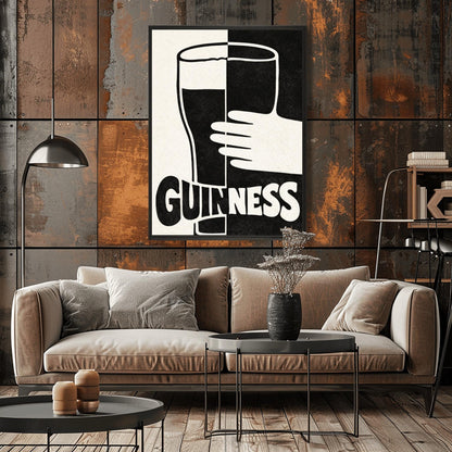 A vertical minimalist graphic split down the center: the left half is cream and the right half is black. A large Guinness pint in the center reverses its colors across the split. A white hand holds the glass from the right. The word "GUINNESS" at the bottom also reverses colors across the divide.