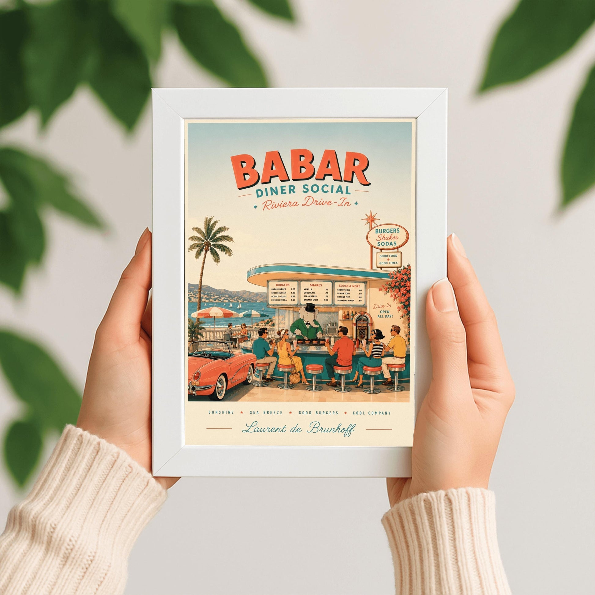 A mid-century style illustration poster titled "BABAR DINER SOCIAL - Riviera Drive-In" at the top. The scene shows an open-air retro diner bar right on the coast of the French Riviera, with a turquoise sea and white sailboats in the background. King Babar, a cartoon elephant in a green suit, bowtie, and top hat, cooks burgers on a grill behind the counter. Stylishly dressed patrons from the 1950s sit on red-topped stools, and a classic pink convertible sports car is parked on the left