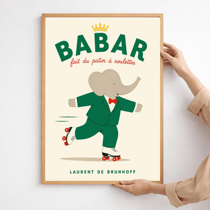 A vertical storybook-style art print of Babar the Elephant roller skating against a cream background. Babar is wearing his signature green suit and red bow tie. He is balanced on white roller skates with red wheels, with one foot lifted behind him. The top of the print features the word "BABAR" in large green letters above the red script text "fait du patin à roulettes" and a small gold crown. The name "LAURENT DE BRUNHOFF" is printed at the bottom.