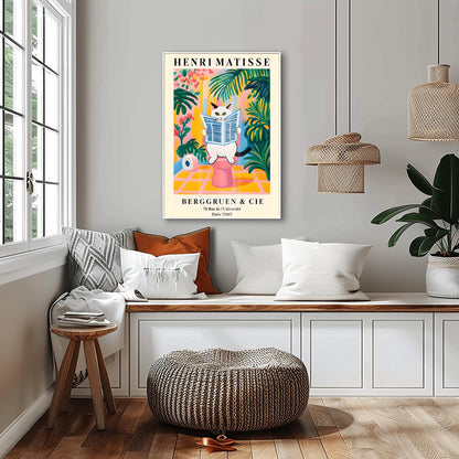 A whimsical, colorful poster in the style of Henri Matisse features an orange and black striped cat with green eyes sitting on a toilet, intently reading a blue-and-white striped newspaper. The bathroom setting is rendered in bold, flat blocks of color, dominated by pink, yellow, and green, with large leafy plants surrounding the cat. A roll of toilet paper is visible to the left. At the top, "HENRI MATISSE" is written in black capital letters.