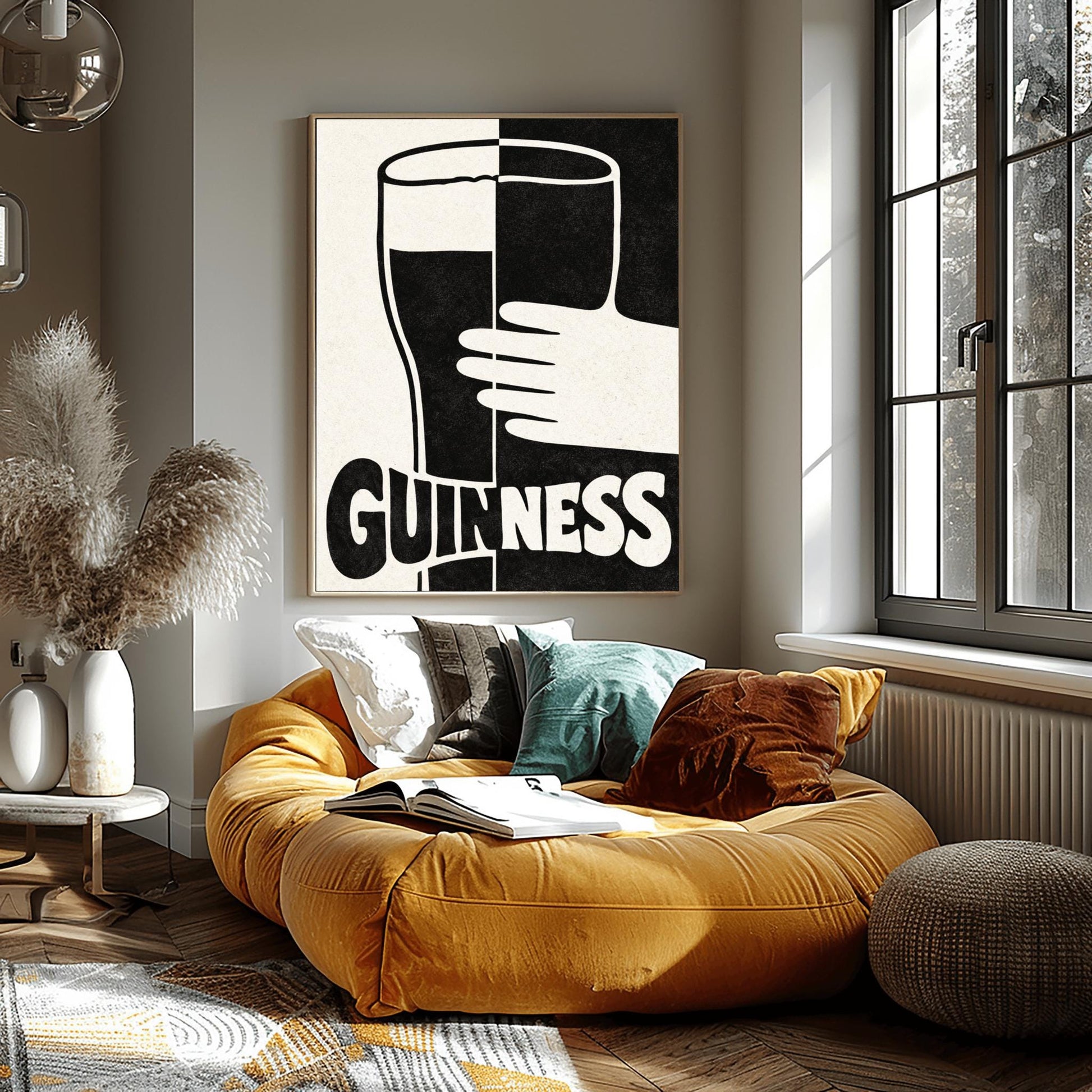 A vertical minimalist graphic split down the center: the left half is cream and the right half is black. A large Guinness pint in the center reverses its colors across the split. A white hand holds the glass from the right. The word "GUINNESS" at the bottom also reverses colors across the divide.