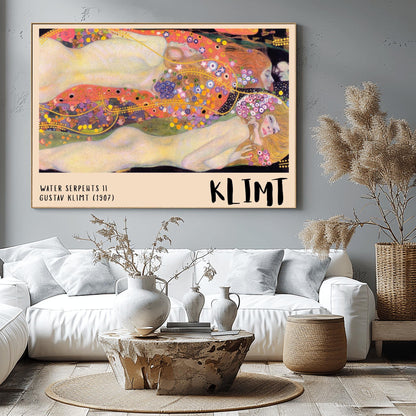 A horizontal museum exhibition poster featuring Gustav Klimt's 1907 painting "Water Serpents II." Reclining female figures are surrounded by a sea of golden spirals, blue and purple flowers, and ornate patterns. The bottom border is cream with bold black text reading "WATER SERPENTS II" and "KLIMT."