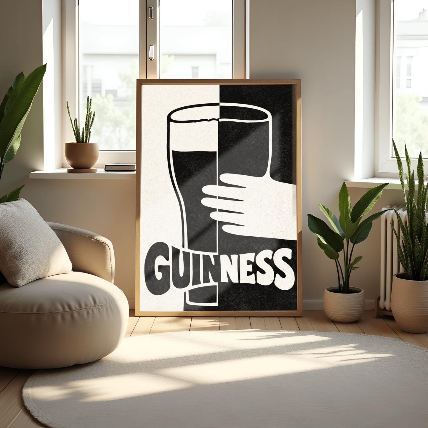 A vertical minimalist graphic split down the center: the left half is cream and the right half is black. A large Guinness pint in the center reverses its colors across the split. A white hand holds the glass from the right. The word "GUINNESS" at the bottom also reverses colors across the divide.