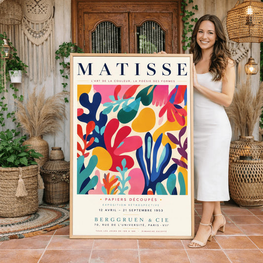 A vertical gallery exhibition poster with a warm cream border. Bold black text at the top reads "HENRI MATISSE". The central artwork is a rectangular block with a solid cobalt blue background, featuring a cream silhouette of an abstract, organic split-leaf design. Below the block, black text reads "PAPIERS DÉCOUPÉS" and "FEUILLE". The bottom of the poster finishes with the text "BERGGRUEN & CIE - 70 RUE DE L'UNIVERSITÉ - PARIS VII".