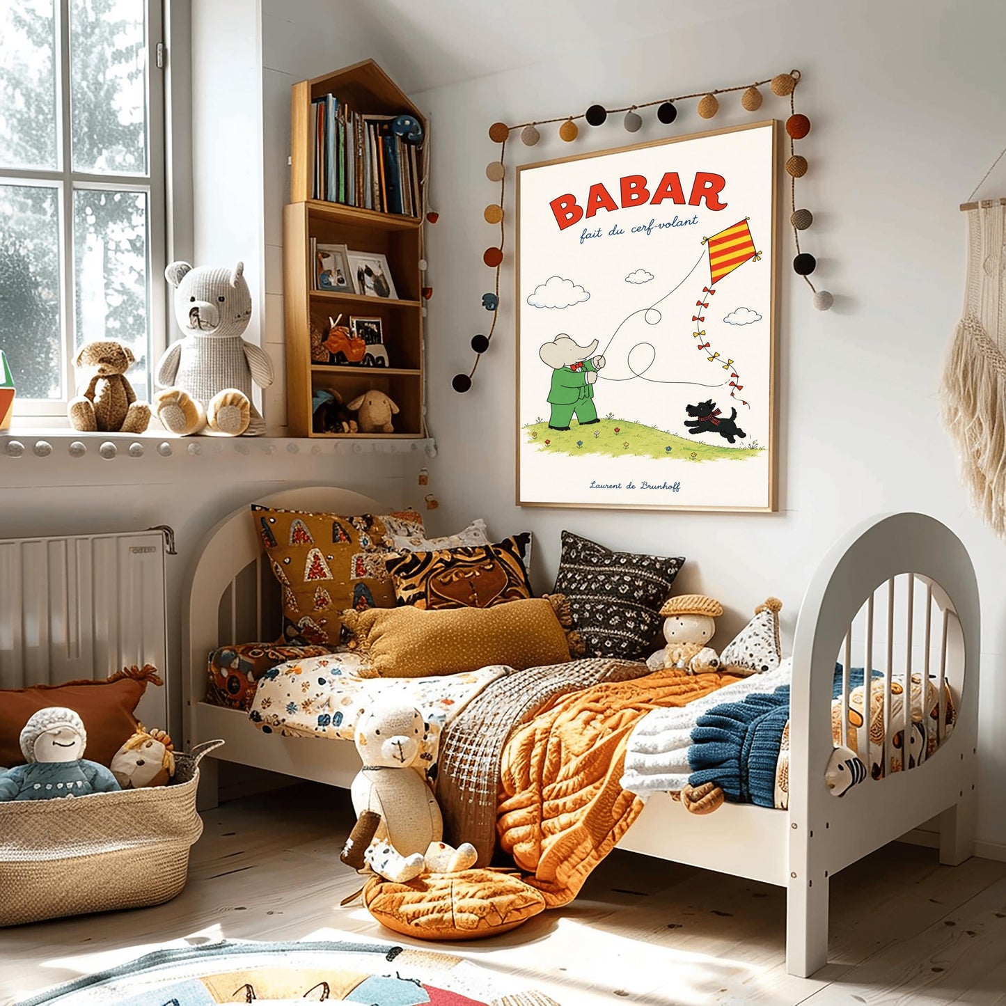 A vertical retro fine art exhibition poster titled "BABAR fait du cerf-volant" on a wide cream border. The top "BABAR" text is printed in a bold red font. The illustration shows an elephant in a green suit and red bowtie flying a red and yellow striped diamond kite on a green grassy hill with small flowers. A small black dog in a plaid scarf runs on the hill below, and the name "Laurent de Brunhoff" anchors the bottom.