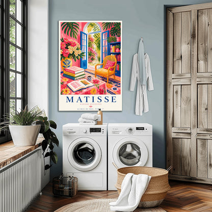 A vertical maximalist art print styled as a Henri Matisse exhibition poster. The scene shows a vibrant interior reading room with hot pink walls and cobalt blue French doors open to a sunlit garden. A yellow cane chair sits next to a bookshelf. In the foreground, a table covered in a pink floral cloth holds a stack of art books, an open book, and a blue coffee mug. Large monstera leaves and various flowers frame the room. Bold black and red text at the bottom reads "MATISSE PAPIERS DÉCOUPÉS"