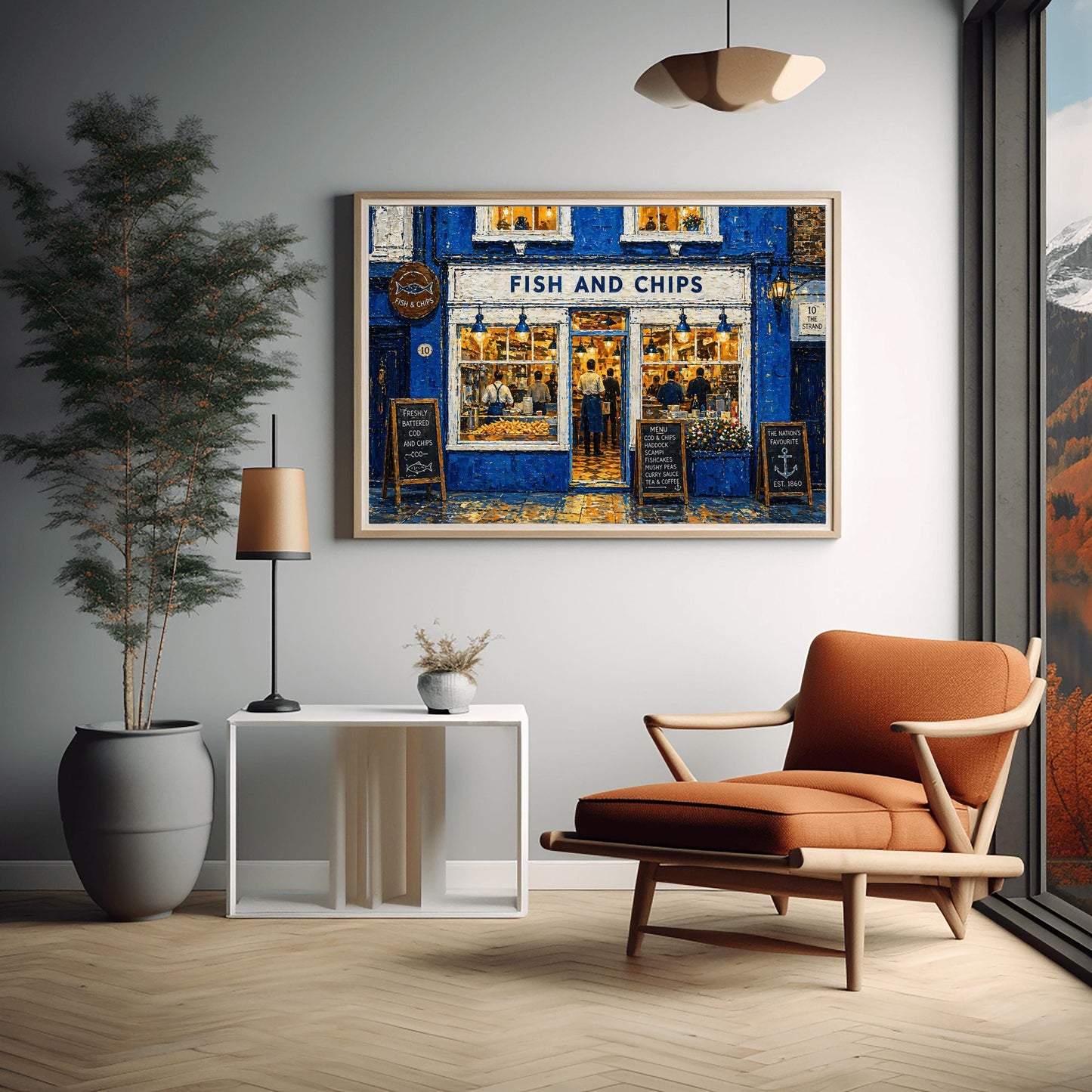 A horizontal impressionist painting of a "Fish and Chips" shop at night. The building is a vibrant cobalt blue with thick, textured brushstrokes. Large, bright windows reveal a warm yellow interior where chefs are working. Outside, three wooden chalkboard signs list the menu and "The Nation's Favourite." The wet pavement reflects the golden light from the shop's interior and blue exterior lamps. A sign on the right reads "10 The Strand."