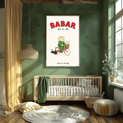 A vertical retro fine art exhibition poster titled "BABAR fait du vélo" on a wide cream border. The top "BABAR" text is printed in a bold red font. The illustration shows an elephant wearing a crown and green suit riding a vintage red bicycle. A smaller baby elephant is sitting inside a brown wicker basket on the handlebars, and a small black dog runs along beside the bike. The name "Laurent de Brunhoff" anchors the bottom.