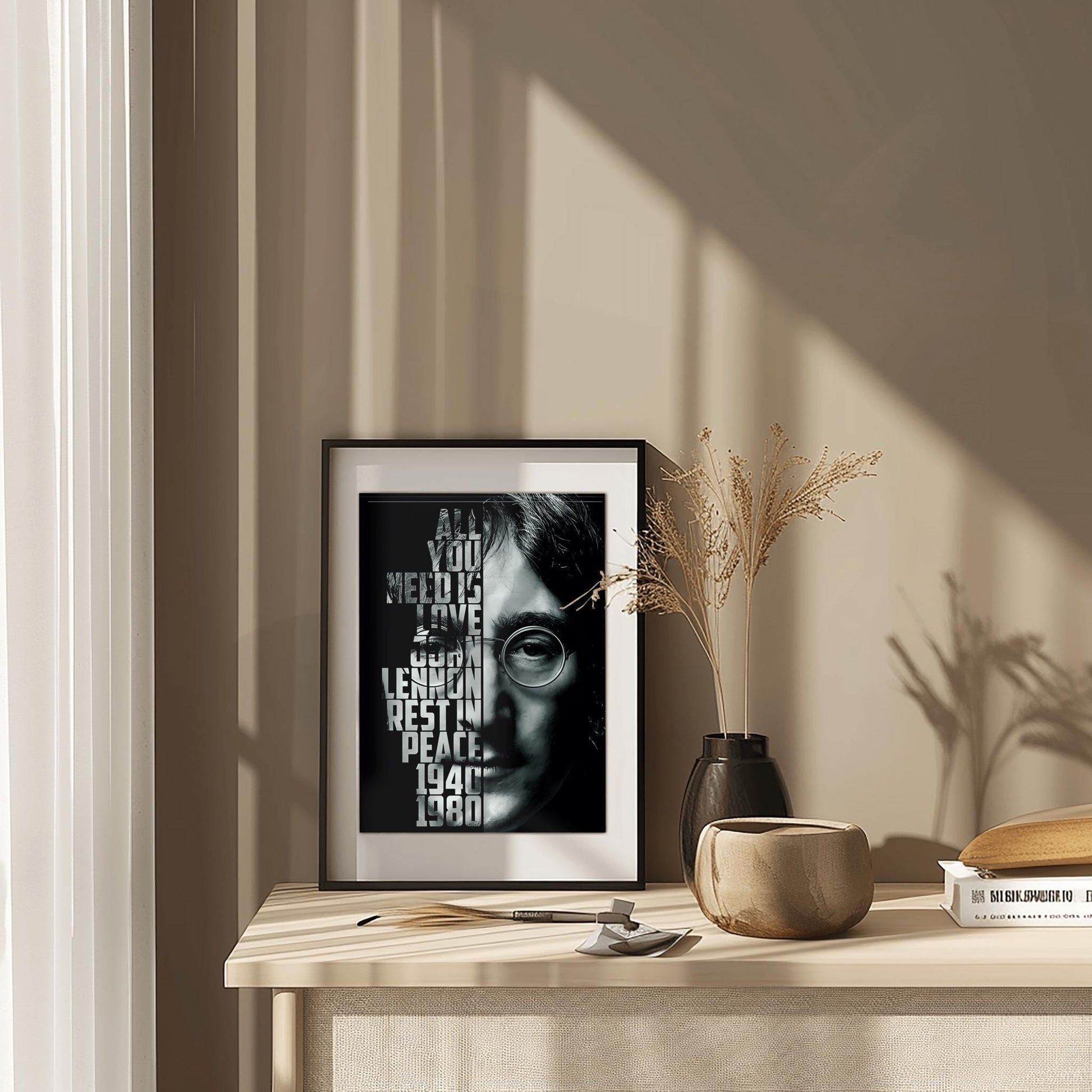 A striking physical poster print featuring a high-contrast black and white portrait of John Lennon, with the text 'ALL YOU NEED IS LOVE' and other meaningful phrases integrated into the design