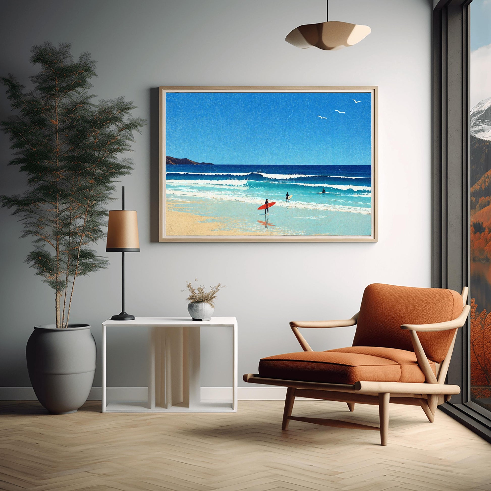 A horizontal minimalist art print of a bright beach day. A vast blue sky with three small white birds in flight sits above a turquoise ocean with gentle white waves. In the foreground, a sandy beach meets the water. A lone surfer in a black wetsuit holds a bright red surfboard on the shore, while two other surfers are further out in the water. A dark cliff is visible on the far left horizon. The style is clean and graphic with a subtle paper texture.