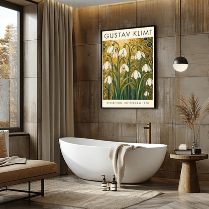 A vertical retro exhibition poster for Gustav Klimt featuring a wide cream-colored border. The central image shows an intricate Art Nouveau illustration of a cluster of delicate white snowdrop flowers with long green leaves reaching upward. The background is an opulent, decorative tapestry of metallic gold patterns, featuring detailed concentric circles, swirling spirals, and tiny mosaic tiles accented with hints of blue and teal.