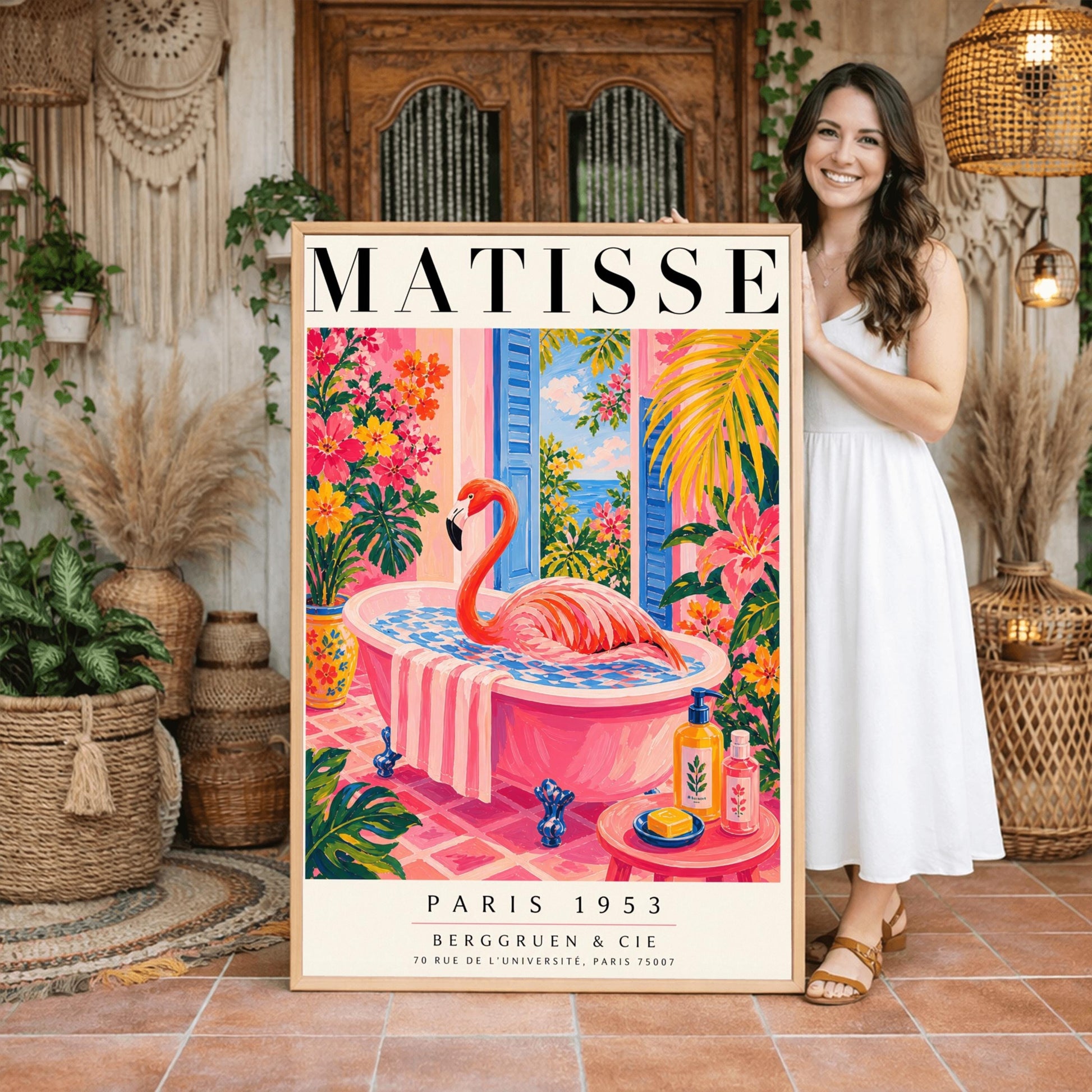 A vertical maximalist art print styled as a Henri Matisse exhibition poster. A vibrant pink flamingo with its long neck curved sits elegantly in a pink clawfoot bathtub. The bathroom features pink tiled floors and walls, with open blue shutters in the background looking out to the sea. The room is filled with tropical greenery and bright pink and orange flowers. A small pink table in the foreground holds soap and cosmetic bottles.